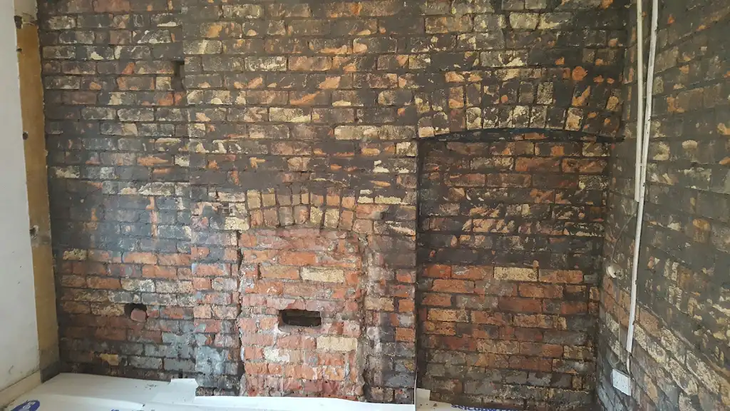 Chimney breast exposed for damp proofing preparation