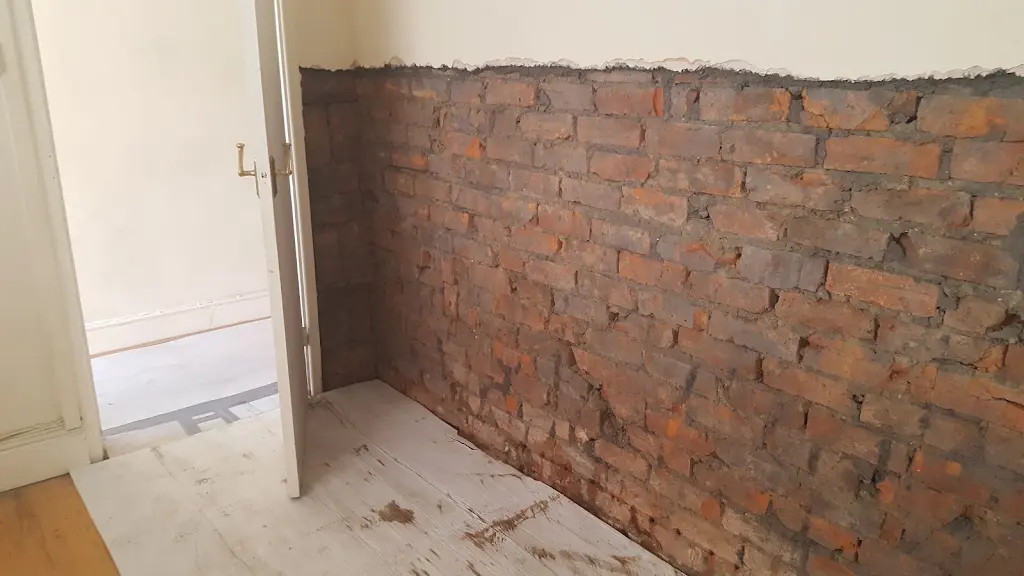 Hallway masonry exposed during damp proofing preparation