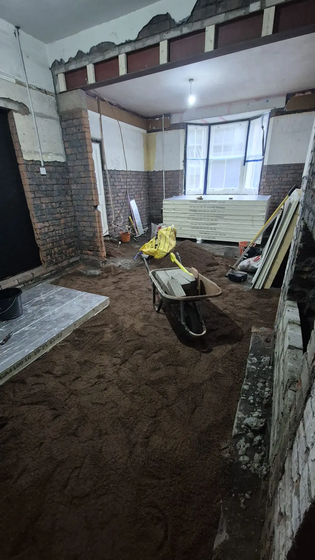 Floor preparation underway with insulation boards and materials ready for the next stage.