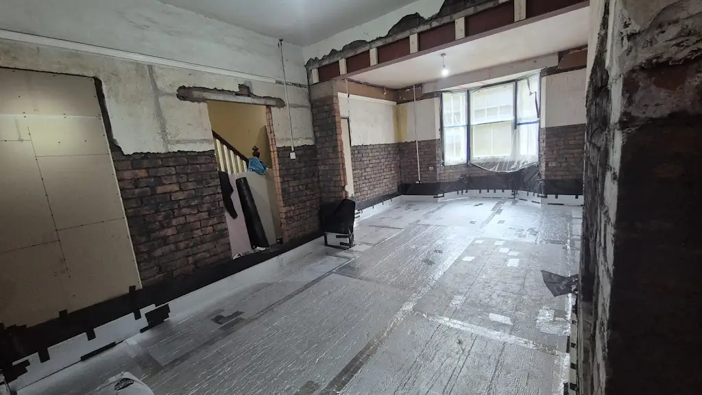 Exposed brickwork and a broad internal opening above the newly insulated floor.