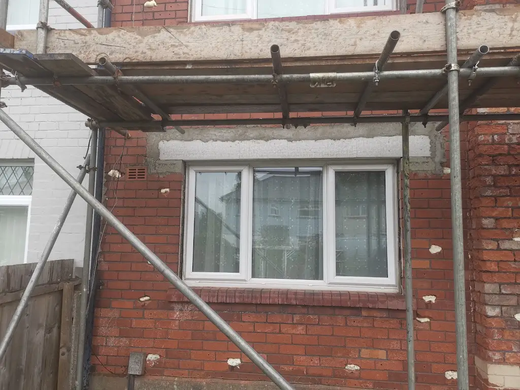Brick window elevation with scaffold and made-good wall-tie replacement points